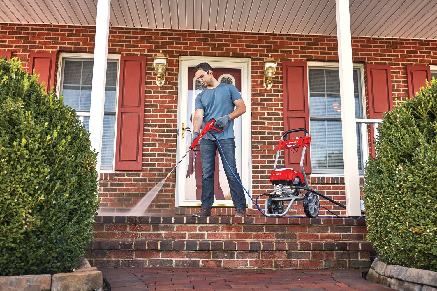 2400 pound per square inch electric cold water pressure washer being used by a person.